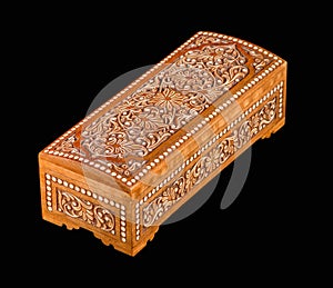 Wooden casket with traditional artistic carving isolated on a black background
