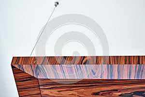 Wooden ceiling panels. Rosewood fineline veneer ceiling panels in the modern office