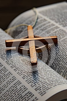 The wooden Celtic Cross is set on the words of the Bible it is a Christian cross with a nimbus or ring that emerged in Ireland