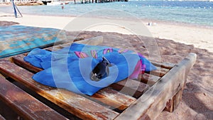 Wooden chair at the beach of background of blue sea