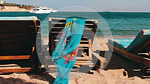 Wooden chair at the beach of background of blue sea and white yacht floats