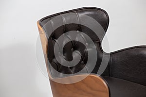 Wooden chair with a black leather seat isolated on a white background