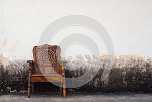 Wooden chair on concrete wall