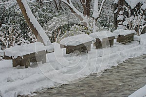 Wooden chair covered white snow on the walkway in Kiyomizu-dera Temple.