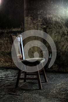 Wooden chair in derelict house photo