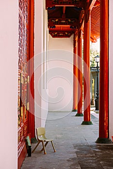 Wooden chair in front of a door to the Hall of Supreme Harmony in the Forbidden City, Beijing, China