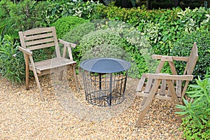 Wooden chair at the green garden. Beautiful garden furniture