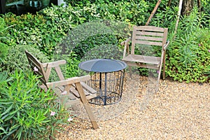 Wooden chair at the green garden. Beautiful garden furniture