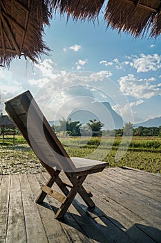 Wooden chair at the homestay terrace with rice paddy view