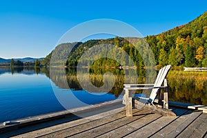 Wooden chair on lakeside pier