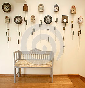 Wooden chair and many coocoo clocks