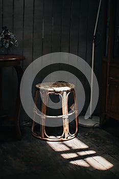 A wooden chair solid light strikes a chair creating a sharp shadow in the sunshine cozy homely atmosphere.