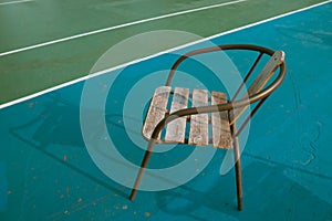 wooden chair on the whote side line of sport court