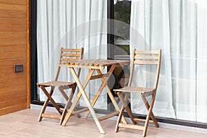 Wooden chairs and brown wood table on the balcony