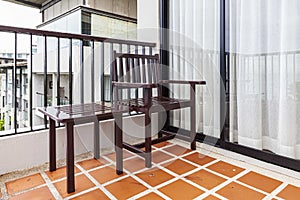 Wooden chairs and brown wood table on the balcony