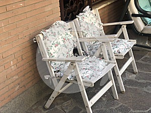 wooden chairs with cushions in home lawn