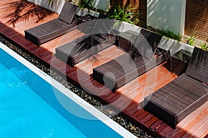 Wooden chairs beside the pool