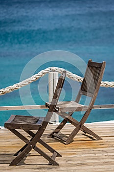 Wooden chairs on a restaurant deck on seaside in Greece