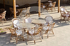 Wooden chairs and round tables in an empty hotel cafe in Egypt Dahab South Sinai