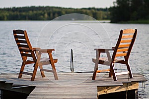 Wooden chairs sitting on the dock