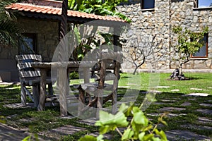 Wooden chairs and table in a beautiful garden