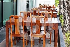 Wooden chairs and tables in a street cafe