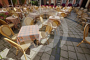 wooden chairs and tables on the terrace