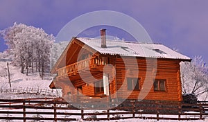 Wooden chalet in wintry view photo