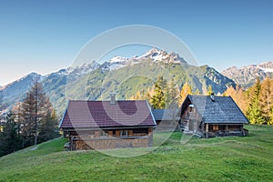 Wooden chalets on mountain meadow