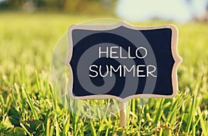 Wooden chalkboard sign with quote: HELLO SUMMER