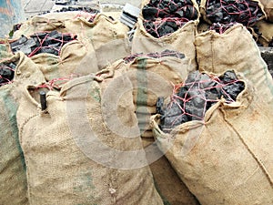 Wooden charcoal packing in hemp sacks