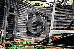 Wooden charred walls of an old abandoned burned-out mansion