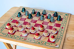 Wooden checker board game with Christmas tree and Santa pieces