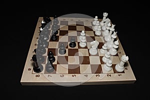 Wooden chess board with the chessmen as a hobby backdrop