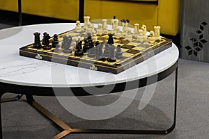 Wooden chess pieces arranged on a chessboard