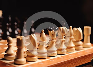 wooden chess pieces on the chess desk. White figures