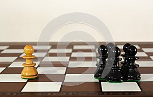 Wooden chess pieces grouped and single one