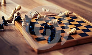 Wooden chess pieces are lying on a chessboard. Concept logic, strategy, defeat