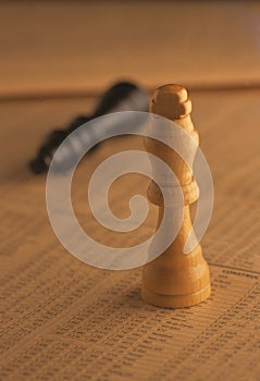 Wooden chess pieces on stock index