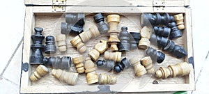A wooden chess tool, played with pawns, is still in the chess box