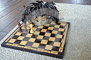 A wooden chessboard with chess pieces and a carnival mask