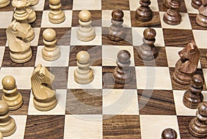 Wooden chessboard with figures closeup