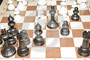 Wooden chessboard and white chessmen as a skill concept