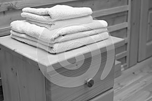 Wooden chest of drawers with bath towel