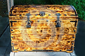 wooden chest in retro style close-up. box with iron locks knocked together, textured burnt boards