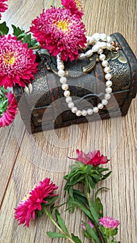 Wooden chest with white pearls and flowers