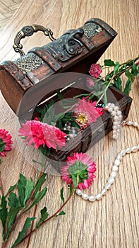 Wooden chest with white pearls and flowers