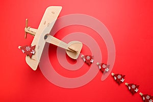 Wooden children`s plane on a red background