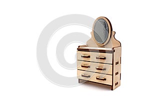 Wooden children`s toy chest of drawers with a mirror assembled from plywood on a white isolated background.