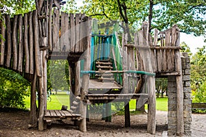 Wooden Childrens Playground. Empty Modern Wooden Children Playground Set On Green Yard In Public Park In Summer Day